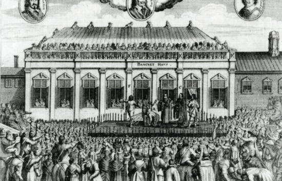 An image shows the execution of Charles the first. Crowds of people surround the stage where he is being executed.