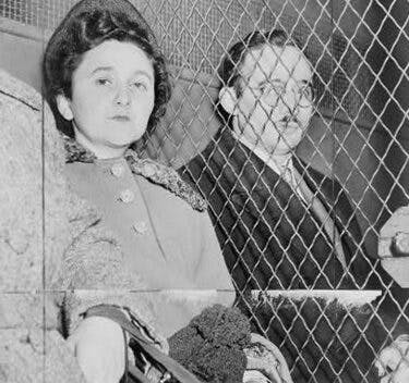 Ethel and Julius Rosenberg separated by a wire screen