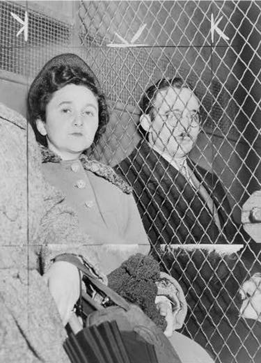 Ethel and Julius Rosenberg separated by a wire screen